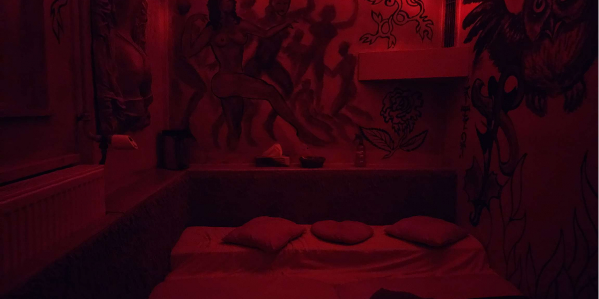 Bett im dunklen Raum mit Wandmalereien
